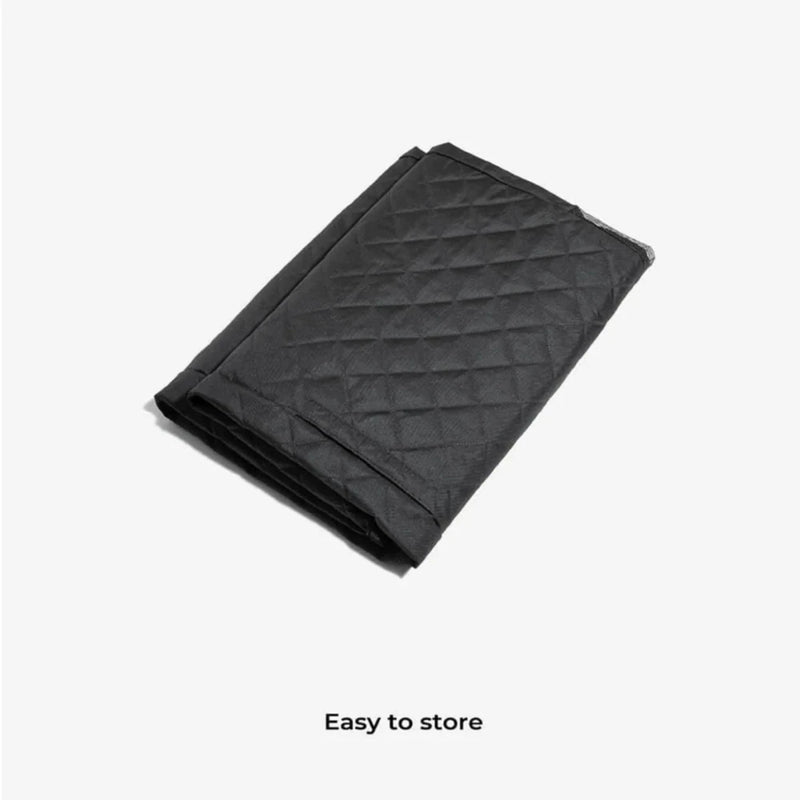 Folded quilted car hammock shown on white background