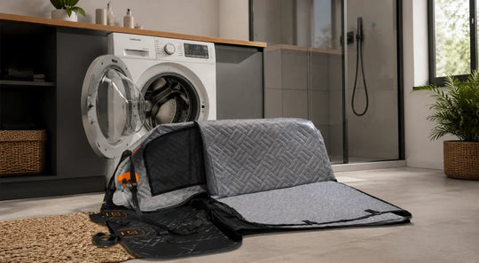 Dog car seat cover with hard bottom placed beside a washing machine before cleaning and panel removal
