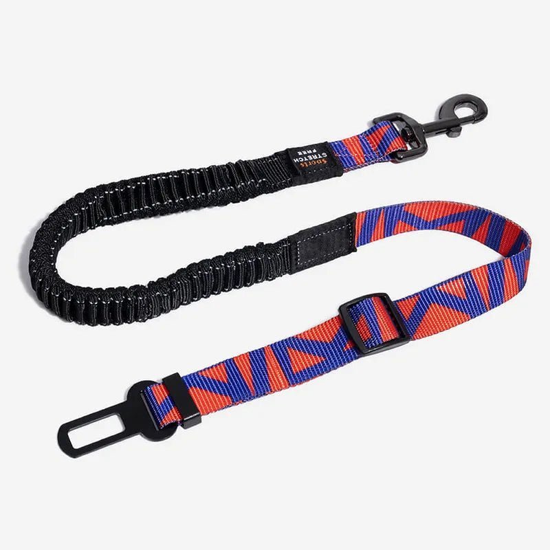 Adjustable dog car seat belt with bungee buffer in red and blue, ensuring pet safety and comfort during travel.