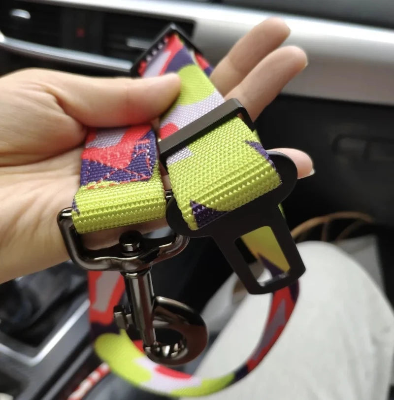 Close-up of adjustable dog car seat belt with sturdy metal buckle and durable nylon strap for safe pet travel.