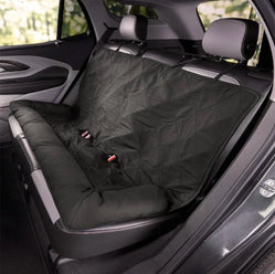 Dark grey quilted car seat cover secured with straps across rear seat