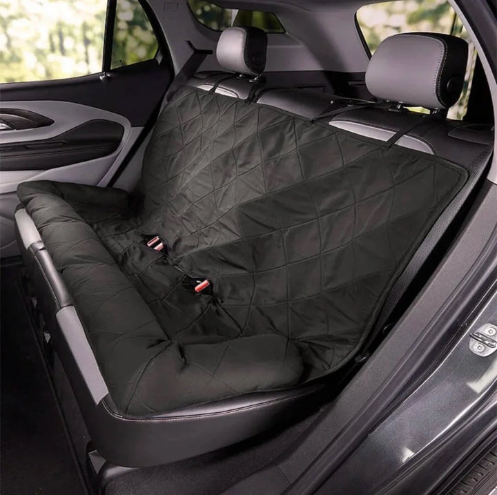 Dark grey quilted car seat cover secured with straps across rear seat