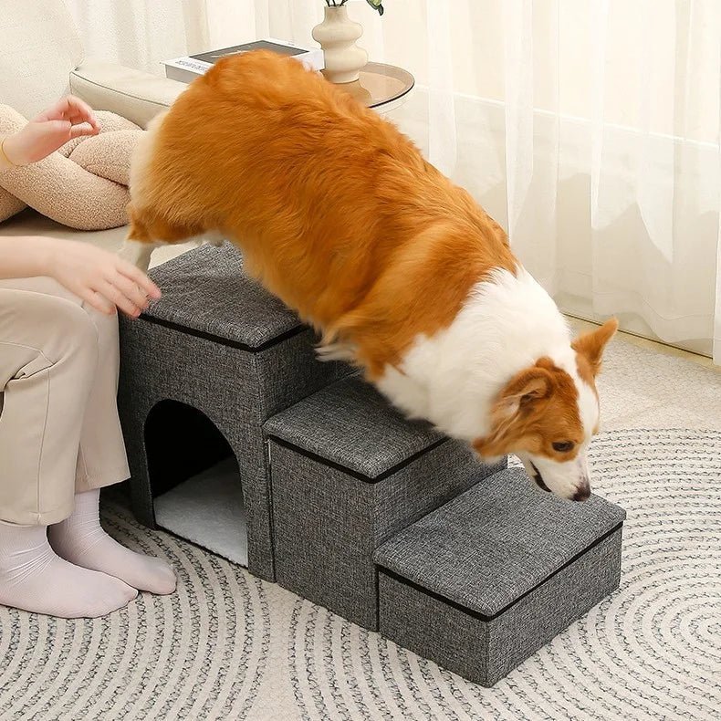 Dog pet stairs in gray fabric used by a corgi indoors
