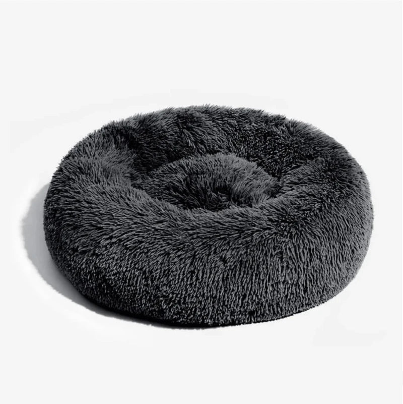 round grey dog bed in dark gray on a clean white background