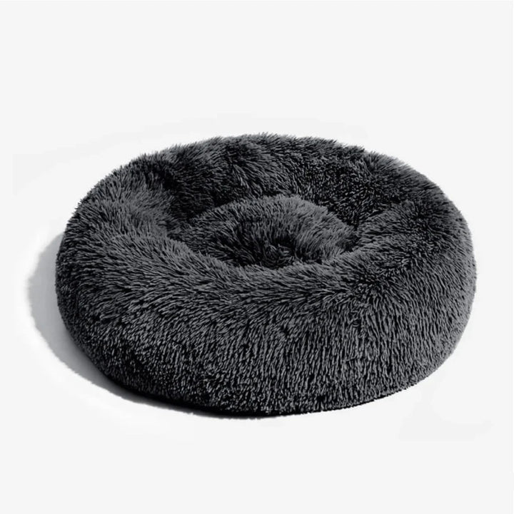 round grey dog bed in dark gray on a clean white background