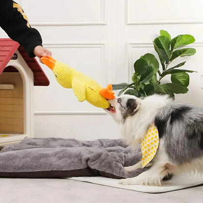 Dog playing tug-of-war with a yellow calming duck toy, designed for stress relief and interactive play.