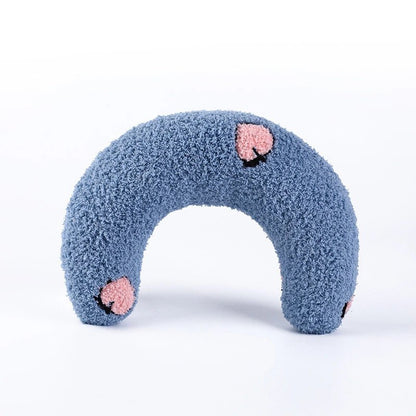 Blue U-shaped calming pet pillow with floral accents, designed to provide comfort and relaxation for pets.