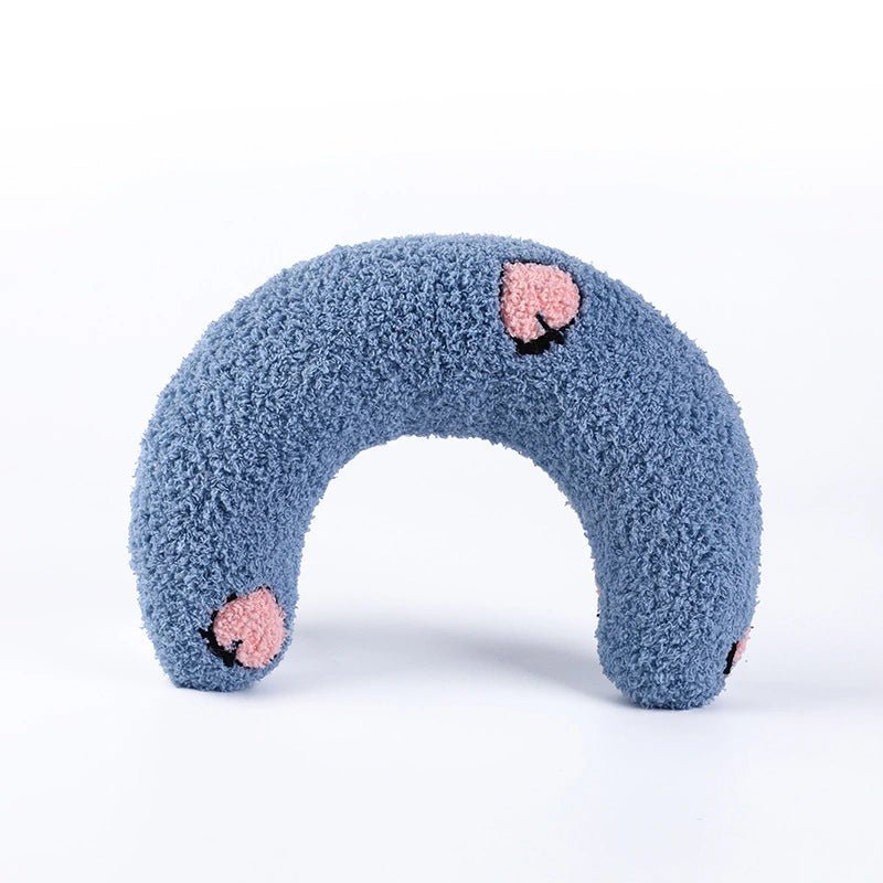 Blue U-shaped calming pet pillow with floral accents, designed to provide comfort and relaxation for pets.