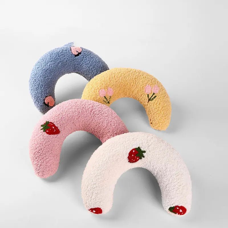 Colorful calming pet pillows in pink, yellow, blue, and white with embroidered strawberries and flowers, perfect for pet relaxation.