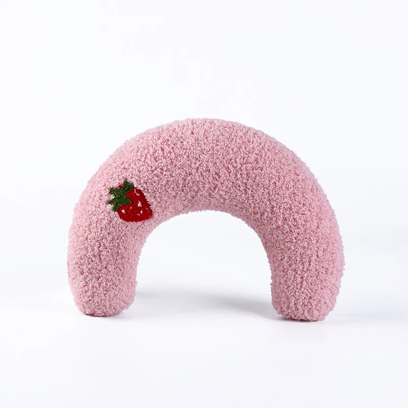 Cozy pink calming pet pillow shaped like a donut, featuring a cute strawberry design for added charm.