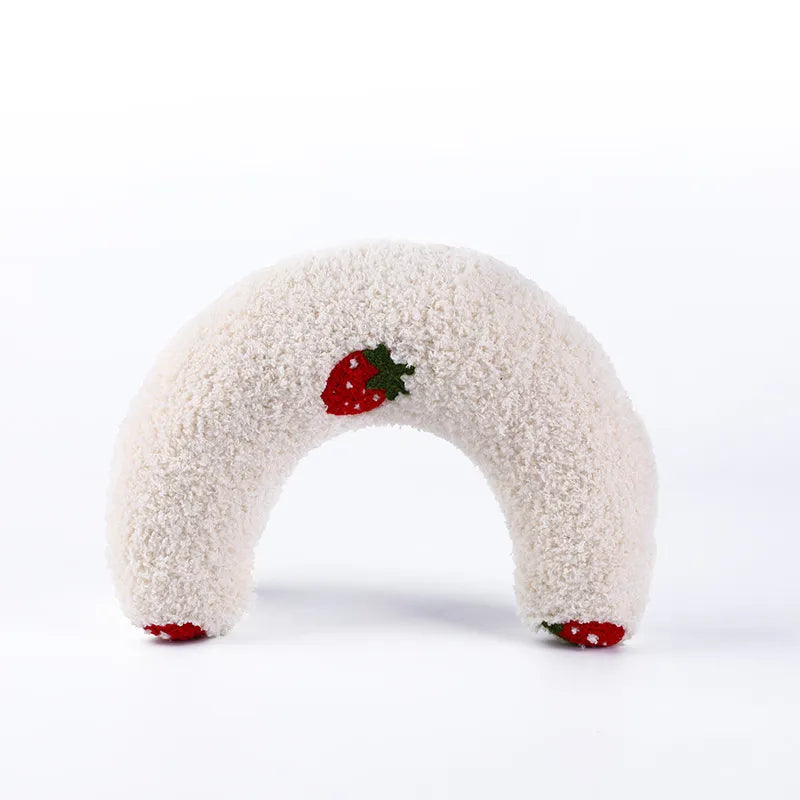 Soft white calming pet pillow shaped like a donut, adorned with a cute strawberry design for added appeal.