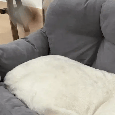 hand pressing soft cushion on best dog bed for car back seat