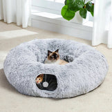 Two cats resting in cat cave tunnel bed on soft carpet