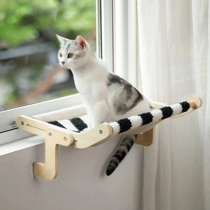 Cat relaxing on a window hammock, designed for comfort and stability, with a black and white striped fabric.