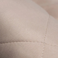 Close-up of stitched fabric texture on padded backseat protector