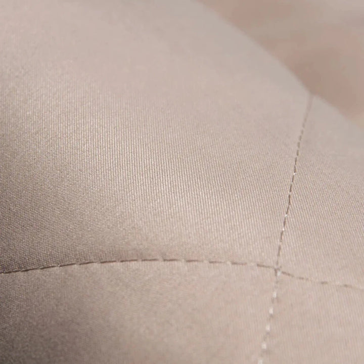 Close-up of stitched fabric texture on padded backseat protector