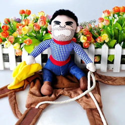 Pet rodeo costume with cowboy rider plush and saddle laid out indoors