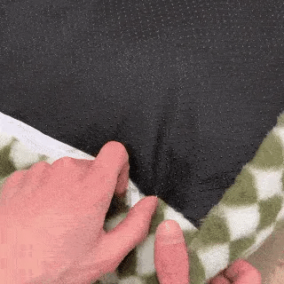 hands unzip the cover to show the removable insert inside a pet sofa bed for dogs