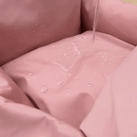 waterproof dog car seat bed with water beading on the pink fabric surface