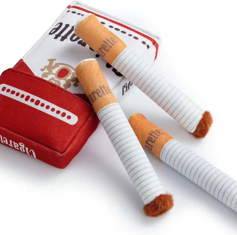 Plush dog chew toy set featuring a cigarette pack and three soft cigars on a white background.