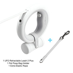 Automatic retractable dog leash set with poop bag holder and extra elastic rope on a white background