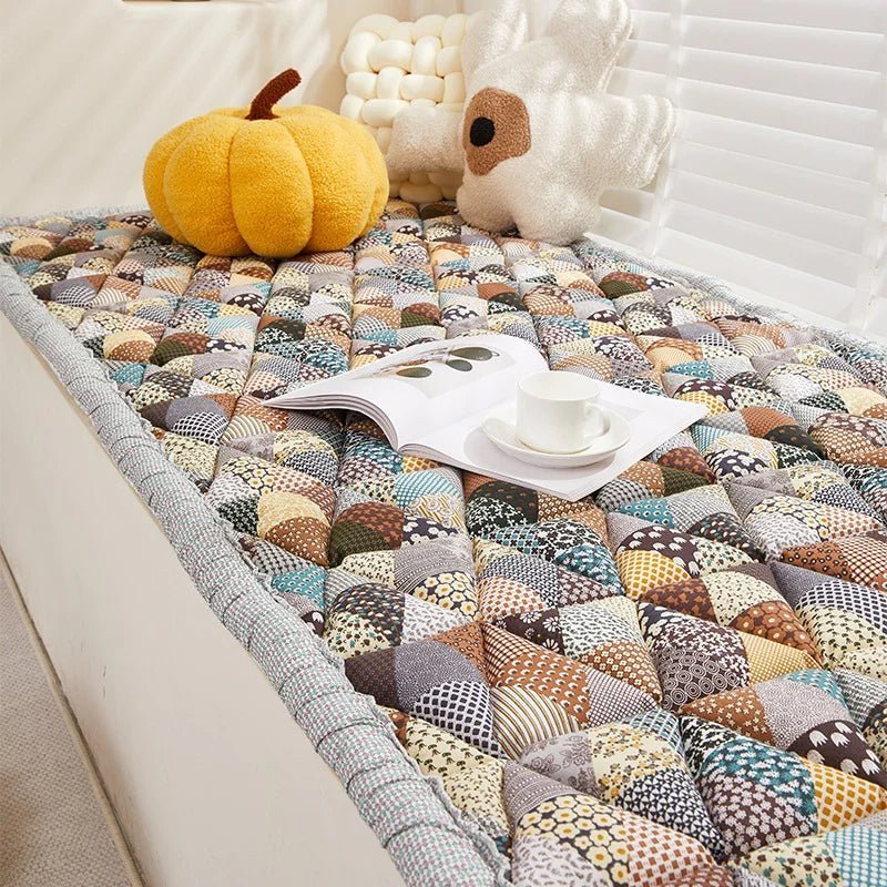 Patchwork sofa protector cover for dogs on couch with book and cup