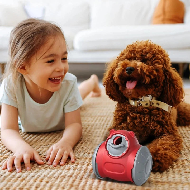 Food dispensing dog toy placed on a rug beside a dog and child