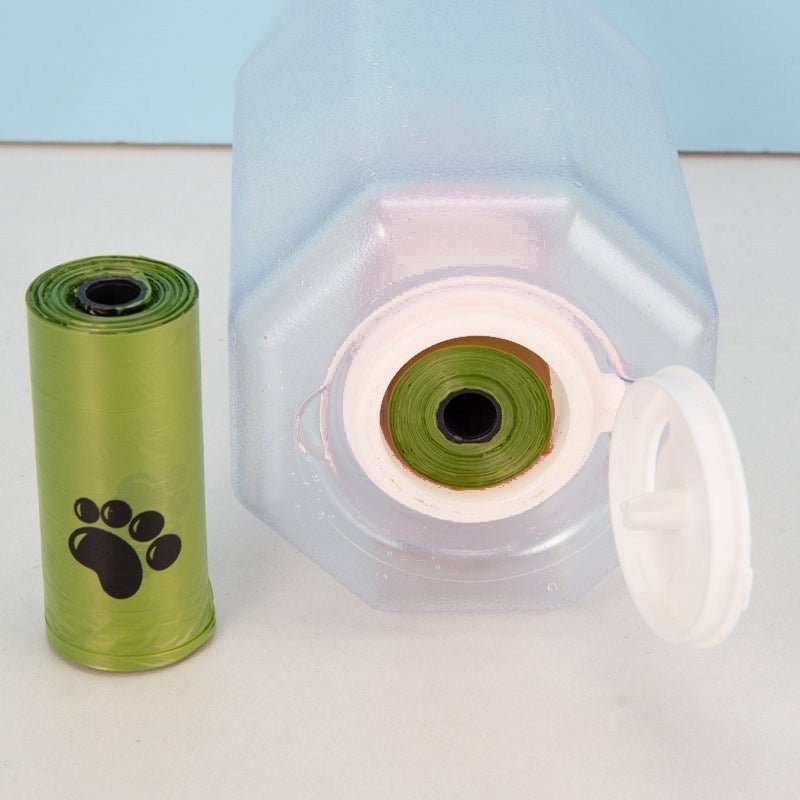 Dog travel water bottle with built-in waste bag dispenser, perfect for convenient hydration and clean-up on the go.