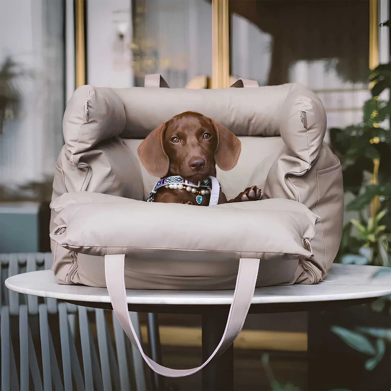 Elevated Dog Car Travel Bed in knight gray with a dog relaxed in a cozy seat booster in the car.