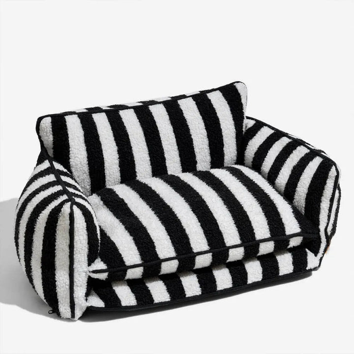 Black dog sofa bed with striped plush fabric on a white background
