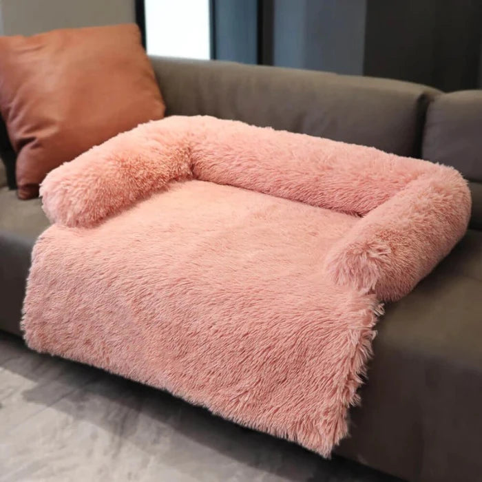 Soft pink fluffy dog couch bed with pillow, perfect for providing your pet a cozy and stylish resting space.