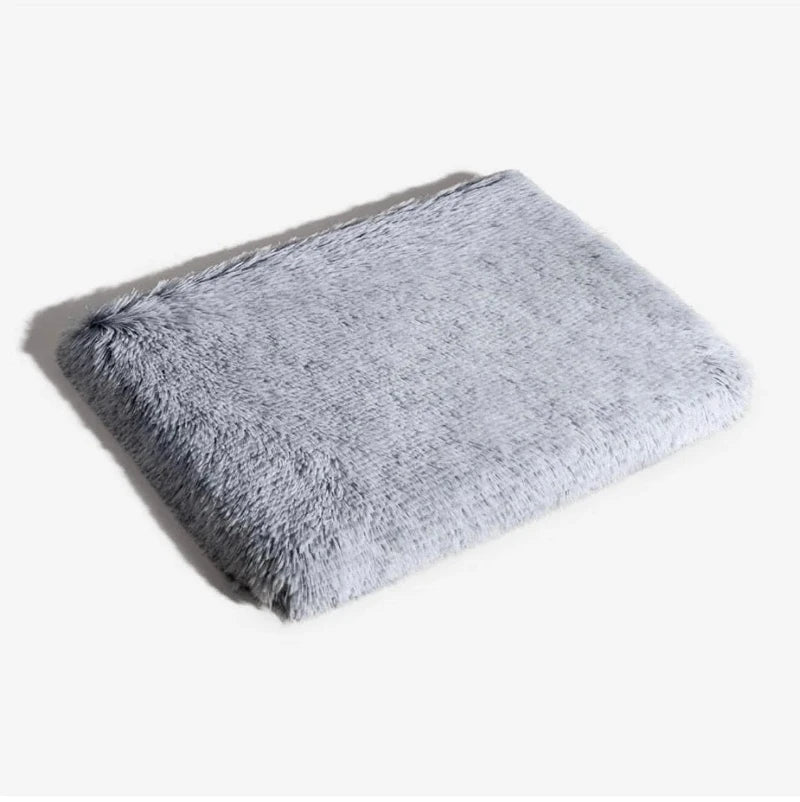 Plush gray orthopedic dog mattress offering soft support and comfort for pets' restful sleep.