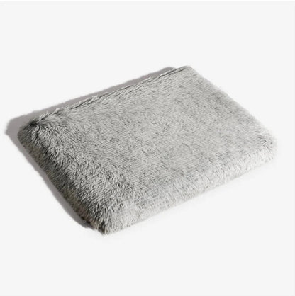 Soft, plush orthopedic dog mattress in light gray, providing comfort and support for pets.