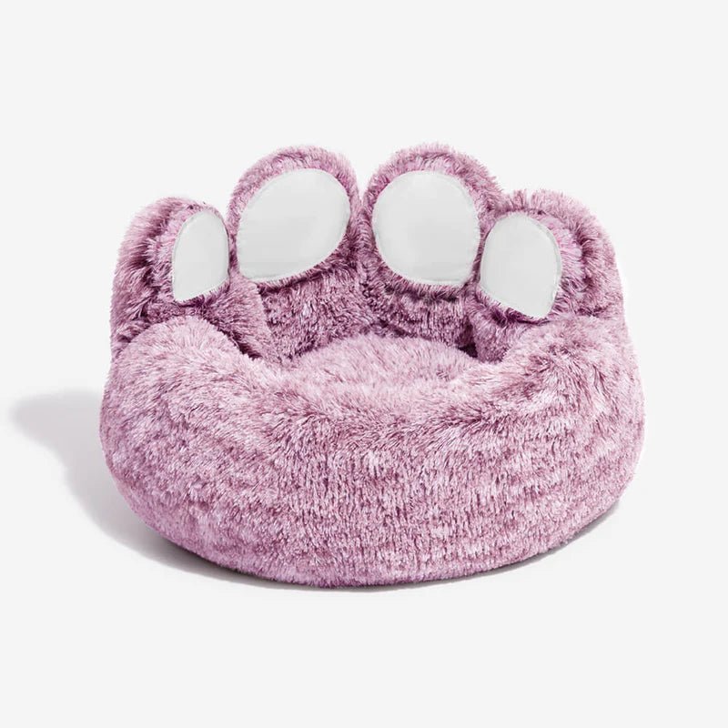 Fluffy paw-shaped dog bed in soft pink, cozy and comfortable design perfect for small dogs or cats.