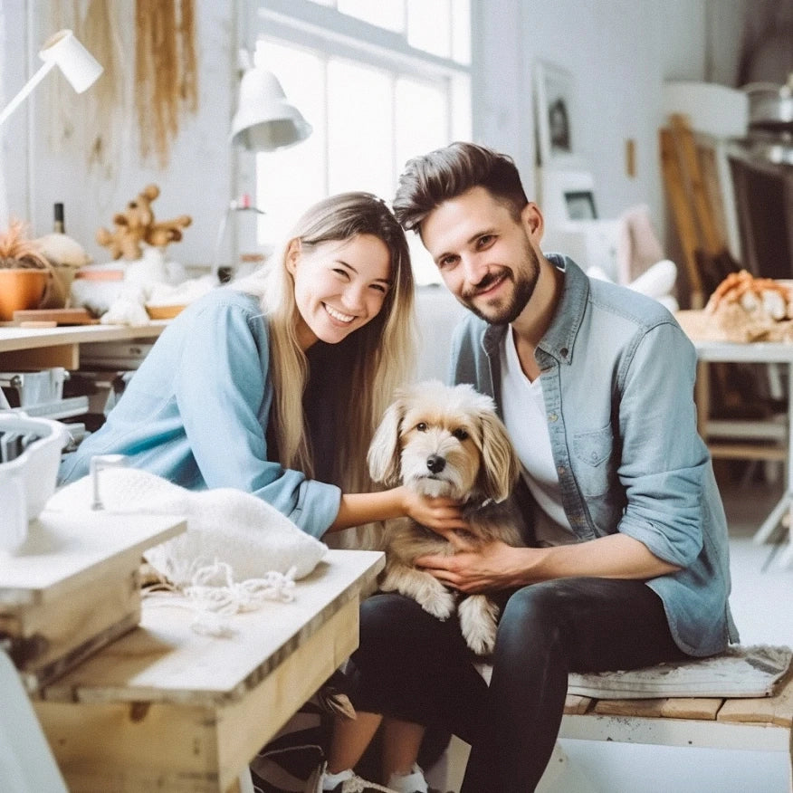 Happy couple with their dog in a cozy studio, showcasing FluffyPuppy's pet-friendly products and lifestyle.