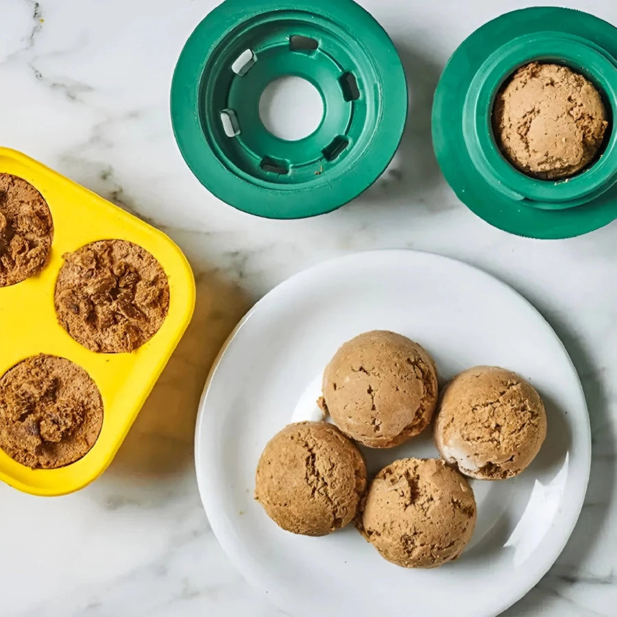 Homemade frozen dog treats in silicone molds, designed for use with a freezable dog toy to keep pets entertained and cool.