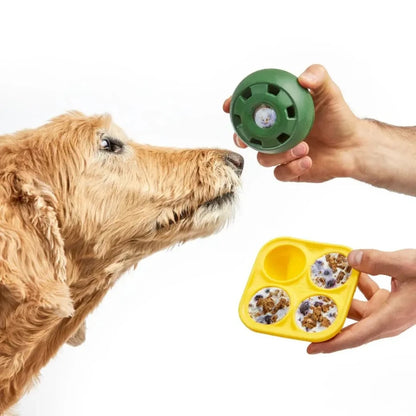 Dog curiously sniffing a freezable dog toy being filled with frozen treats, highlighting treat-dispensing functionality.