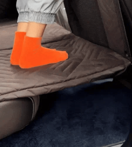 feet pressing into a hard base dog seat cover to show firm support underneath