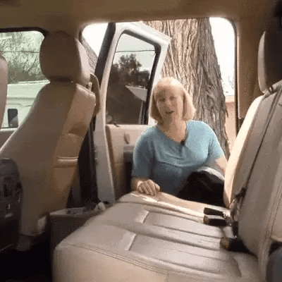 Woman easily setting up waterproof dog hammock for car