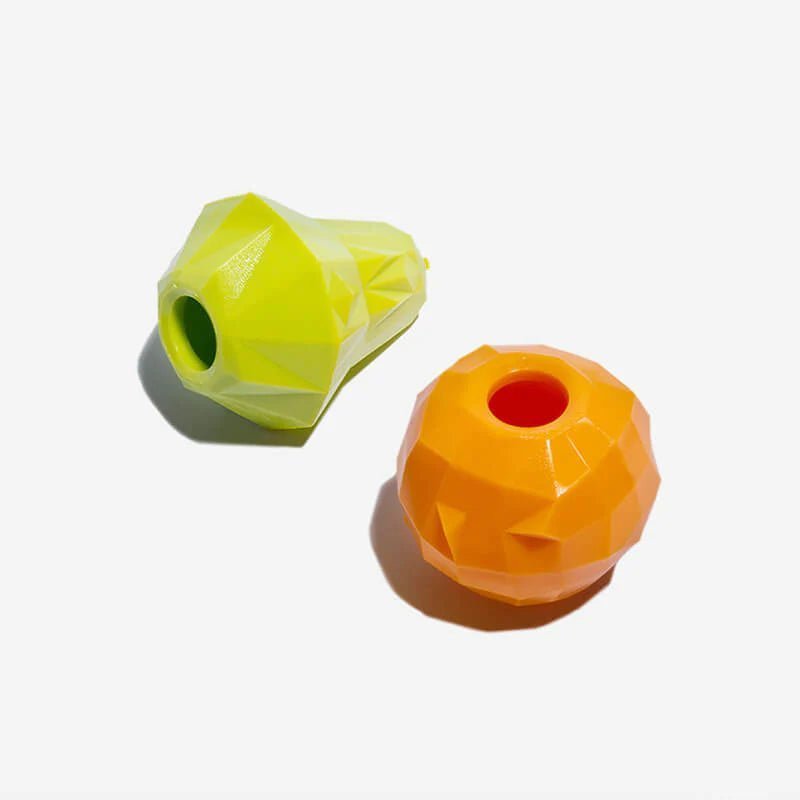 Set of geometric green and orange interactive dog treat toys, designed for mental stimulation and treat dispensing.