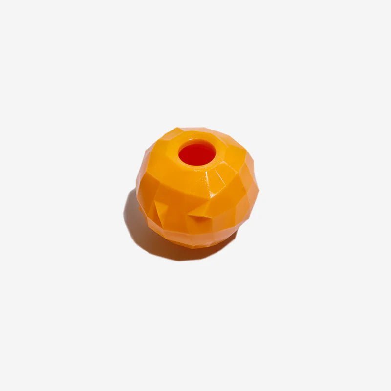 Orange interactive dog treat toy with geometric design, ideal for dispensing treats and providing mental stimulation.