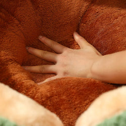 Hand pressing the cushion inside plush cactus cat bed close up