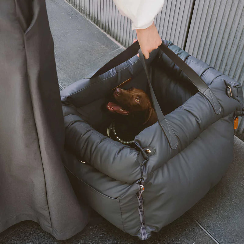 Luxury elevated dog car travel bed in a convenient carrying case with a black dog resting comfortably inside.