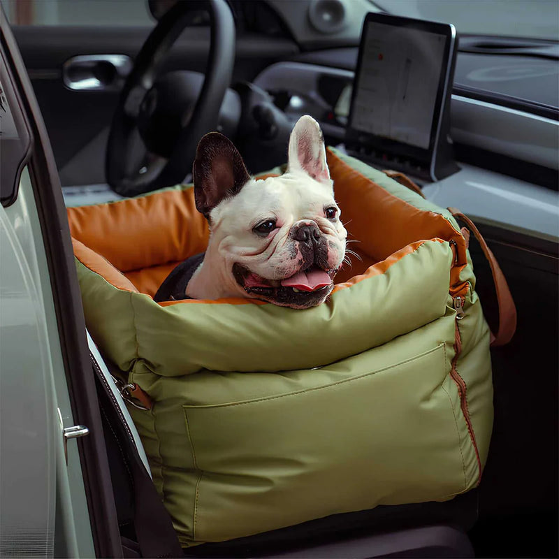 Luxury Elevated Dog Car Travel Bed in orange and green with a dog comfortably resting in a car seat booster.