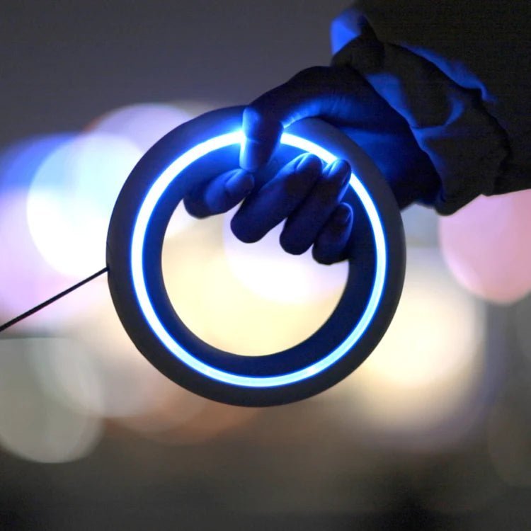 Close-up of blue LED-lit MOESTAR UFO retractable dog leash, perfect for night walks and enhanced visibility