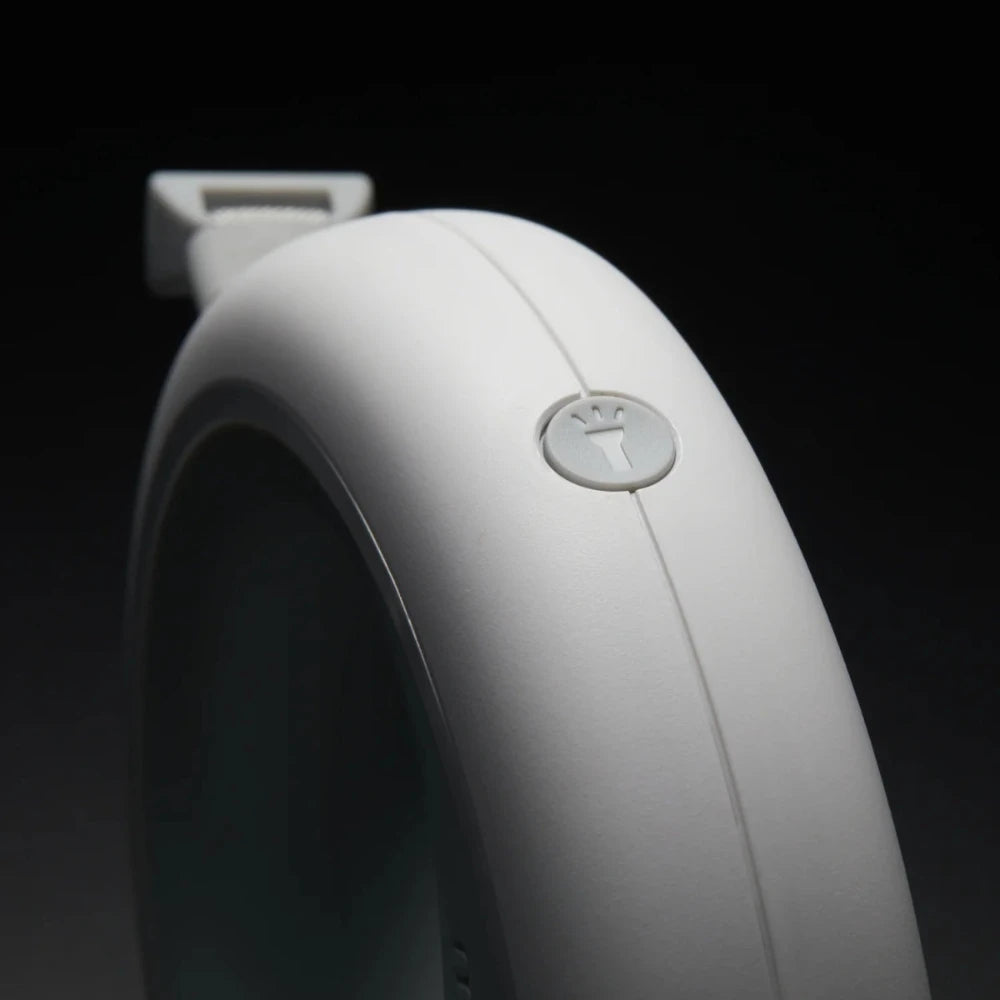 Close-up of the MOESTAR UFO retractable dog leash button, showcasing its sleek design and functionality.