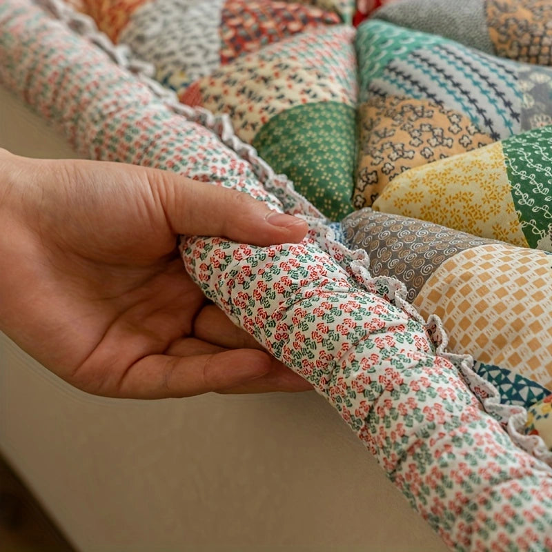 Hand holding a patch of multicolored sofa cover