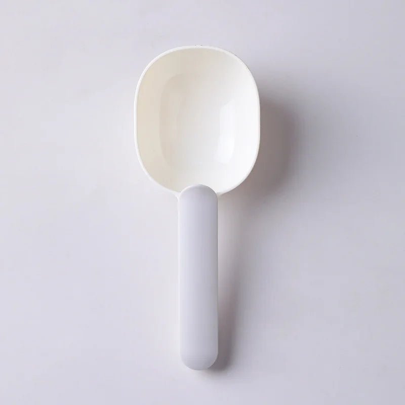 Gray white pet food scoop shown on a gray background