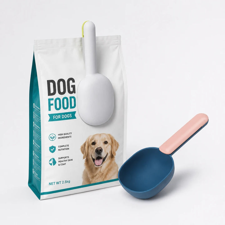 Pet food scoop and clip attached to a bag of dog food beside a blue scoop