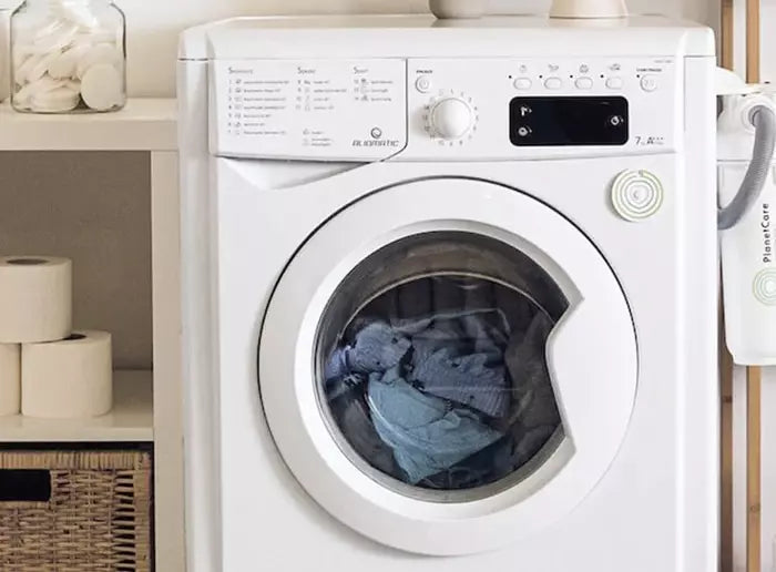 pet proof sofa cover inside a washing machine, ready for easy cleaning